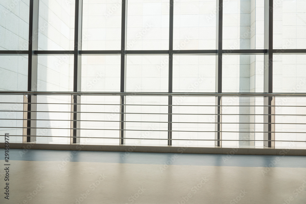 Modern interior large floor to ceiling windows bright business space background Modern interior large floor to ceiling windows bright business space background