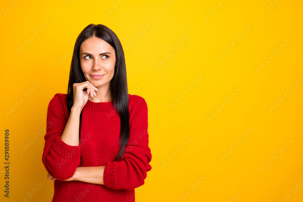 Portrait of minded girl think look at copyspace wear red jumper isolated over yellow background Portrait of minded girl think look at copyspace wear red jumper isolated over yellow background