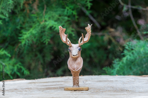 toy deer head on a stump © serikbaib