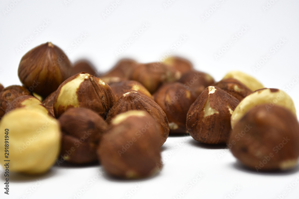 Heap of hazelnuts on a white background. Raw hazelnuts isolated on white background.