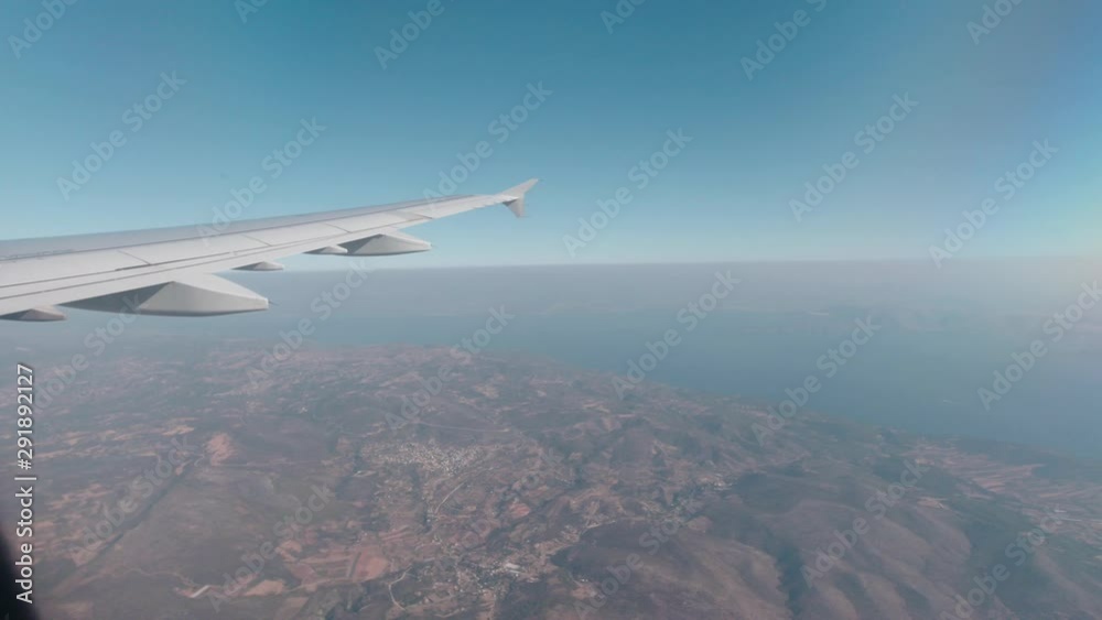 View of the wing of a plane from inside whilst flying View of the wing of a plane from inside whilst flying