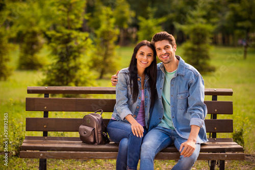 Portrait of his he her she nice attractive lovely charming amorous affectionate cheerful cheery married spouses wearing denim embracing in green wood forest outdoors