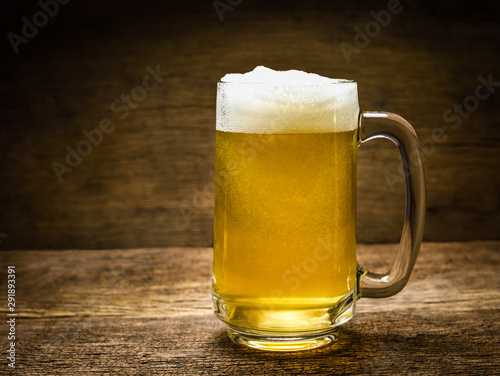 Glass beer on wooden background