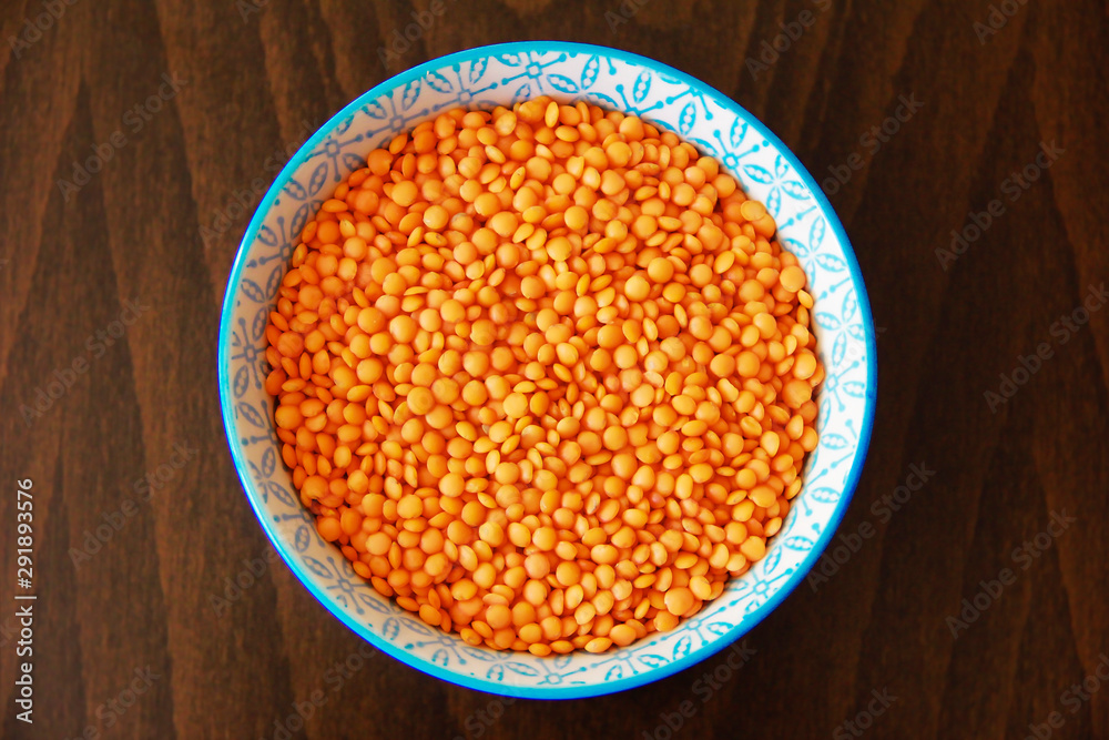 orange dry small oriental lentil groats in a ceramic white plate orange dry small oriental lentil groats in a ceramic white plate
