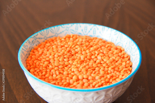 orange dry small oriental lentil groats in a ceramic white plate
