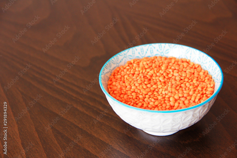 orange dry small oriental lentil groats in a ceramic white plate orange dry small oriental lentil groats in a ceramic white plate
