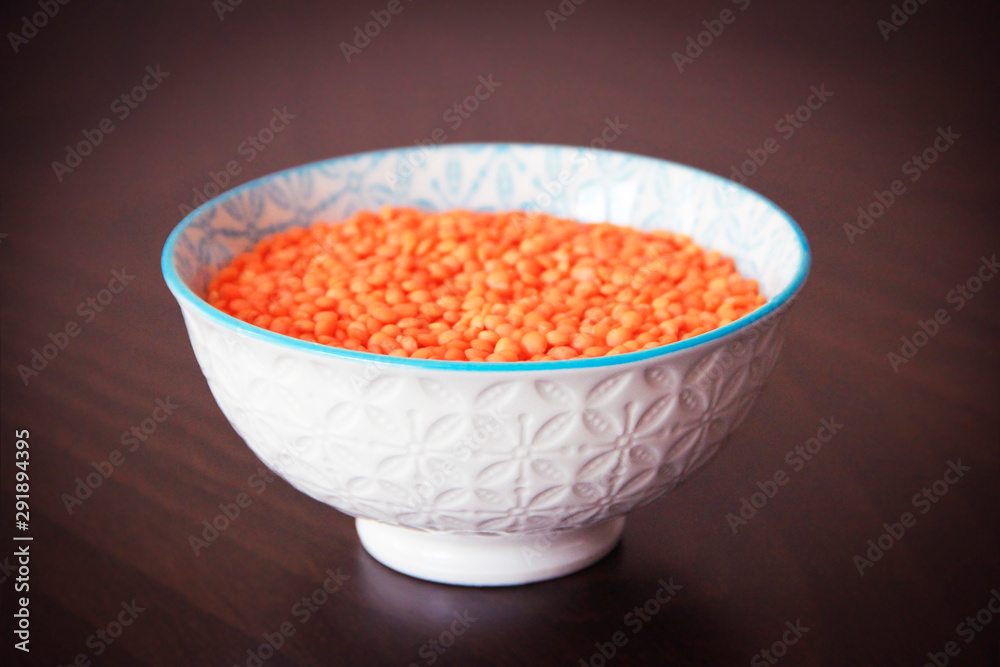 orange dry small oriental lentil groats in a ceramic white plate orange dry small oriental lentil groats in a ceramic white plate