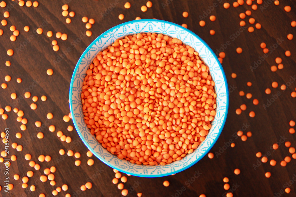 orange dry small oriental lentil groats in a ceramic white plate orange dry small oriental lentil groats in a ceramic white plate