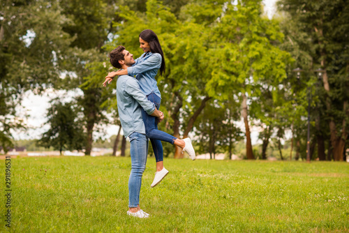 Full body profile photo of overjoyed pair spending best date in green park wear casual denim outfit