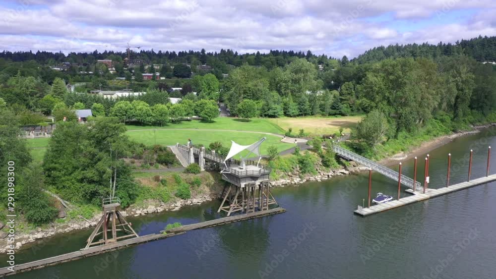 Park aeirial orbit over river showing boat dock and gazebo