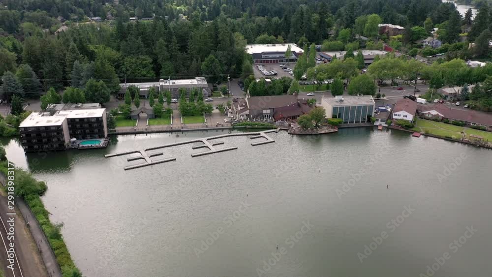 aerial orbit of downtown lake oswego showing docks and lake