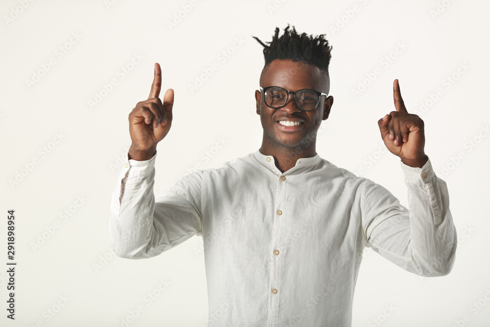 handsome young african man in glasses and white shirt on a white background