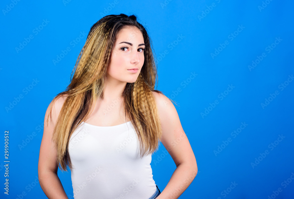Styling cosmetic product. Crimped hairstyles. Woman stylish hairstyle on blue background. Hair crimping method styling hair becomes wavy. Hairdresser salon. Damaged hair. Voluminous crimped hair Styling cosmetic product. Crimped hairstyles. Woman stylish hairstyle on blue background. Hair crimping method styling hair becomes wavy. Hairdresser salon. Damaged hair. Voluminous crimped hair