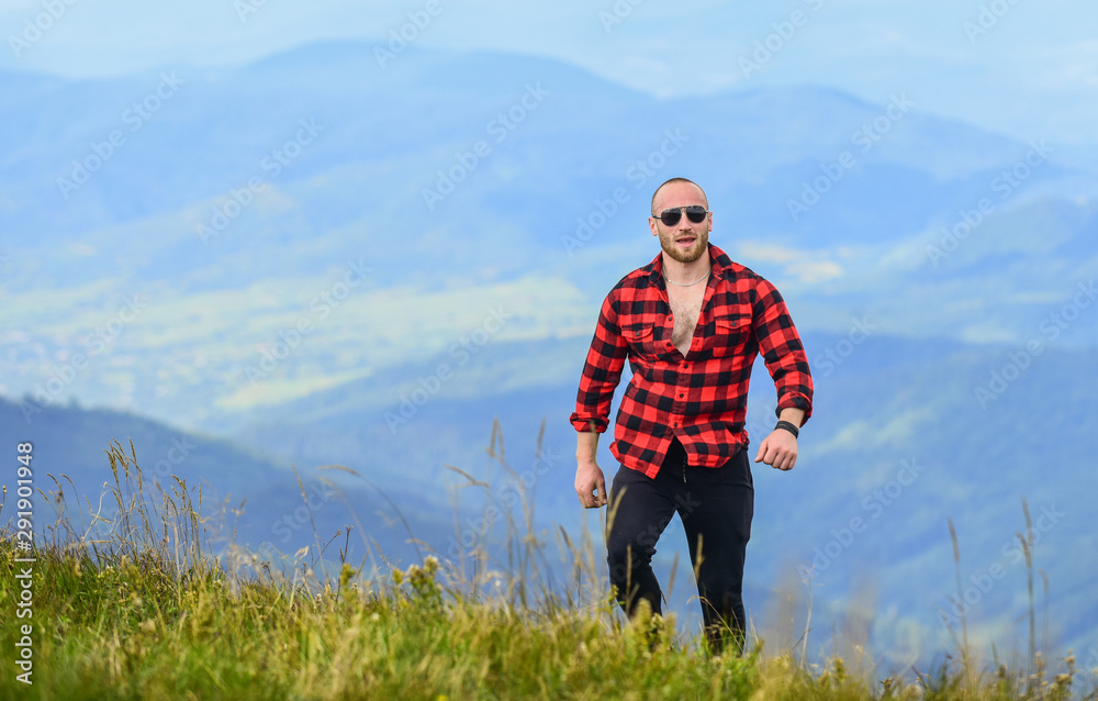 Power of nature. Man stand on top of mountain landscape background. Hiking concept. Discover world. Masculinity and male energy. Tourist walking mountain hill. Natural power. Masculine power