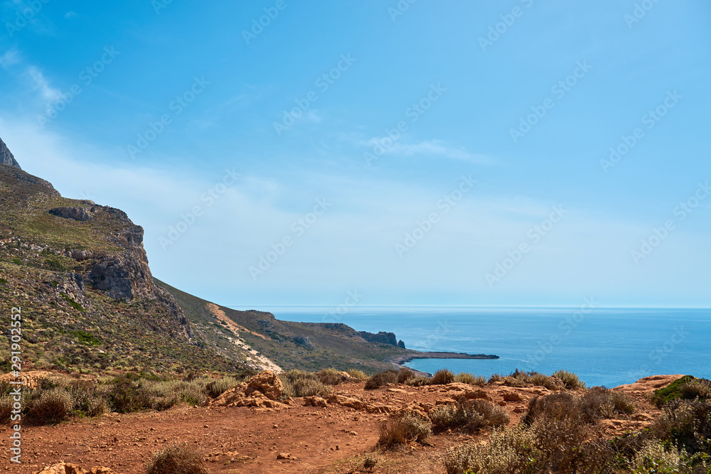 Sea coast in Kissamos Crete, Greece with blue sea, clear sky and horizon on a background. Copy space. Sea coast in Kissamos Crete, Greece with blue sea, clear sky and horizon on a background. Copy space.