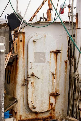 Hatch to rusting wheelhouse on aging fishing boat in Fairhaven