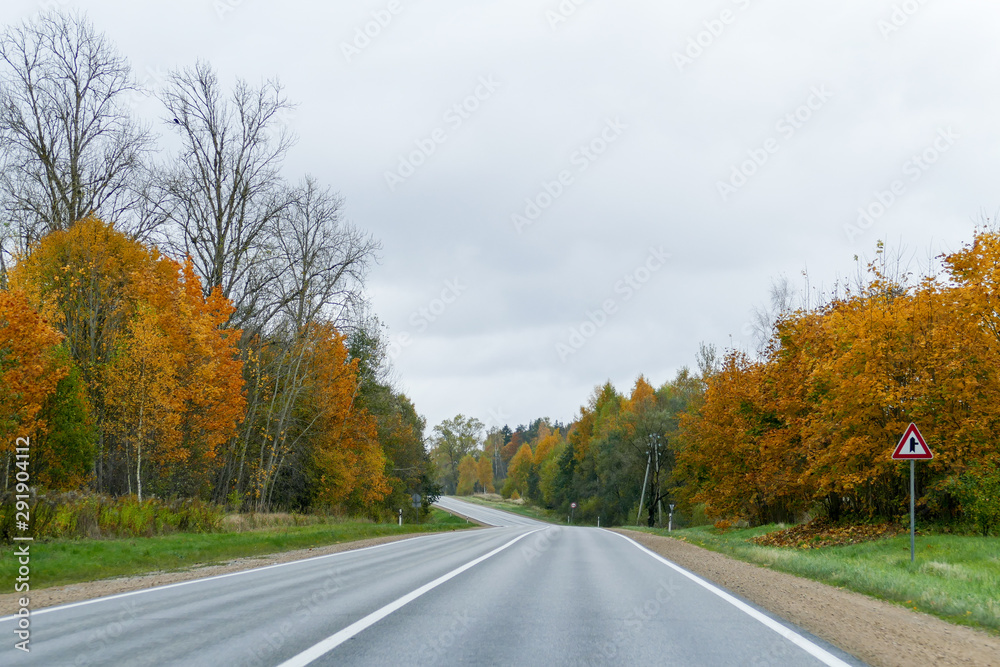 Autumn scene with winding asphalt road in the countryside. Autumn scene with winding asphalt road in the countryside.