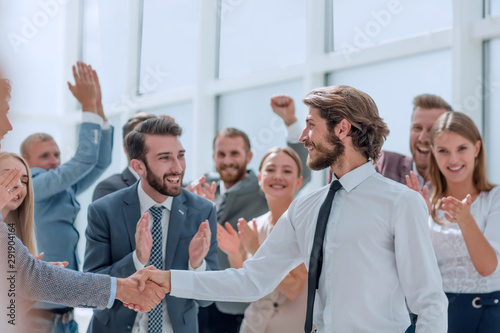 happy business team congratulating young business partners