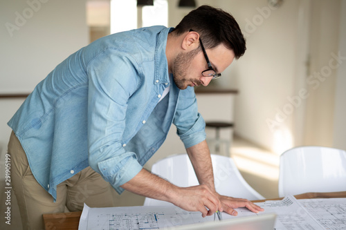 Architect working on drawing table in office