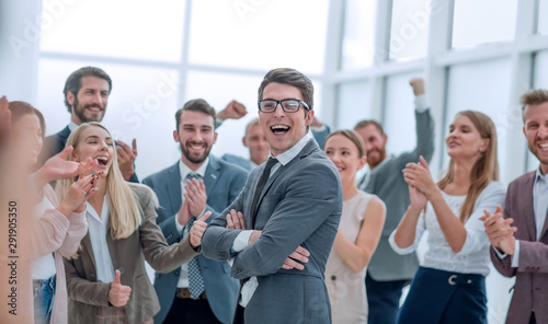 corporate group of employees congratulating each other on the victory photo