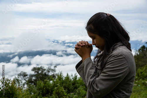 Girl enjoying nature and praying to god.