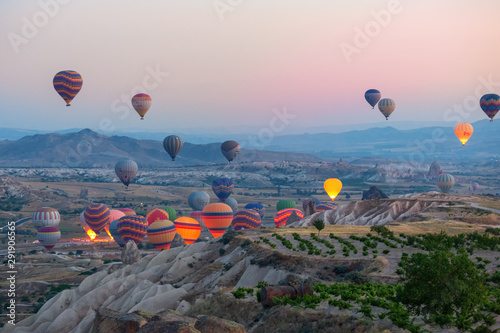 Interesting rocky terrain and a lot of airy multicolored balls in the air. Turkey. Cappadocia. © slava2271