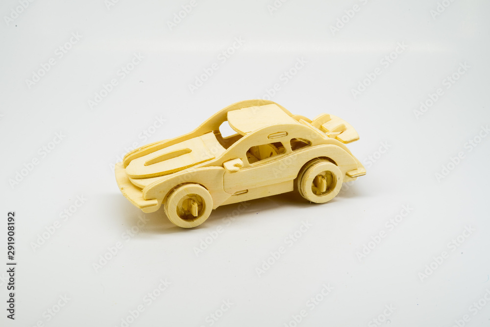 Wooden figurine of a car on a white background. Minimalism. The concept of car insurance, buying and selling cars. Repair and maintenance of vehicles. A wooden toy. banner Wooden figurine of a car on a white background. Minimalism. The concept of car insurance, buying and selling cars. Repair and maintenance of vehicles. A wooden toy. banner