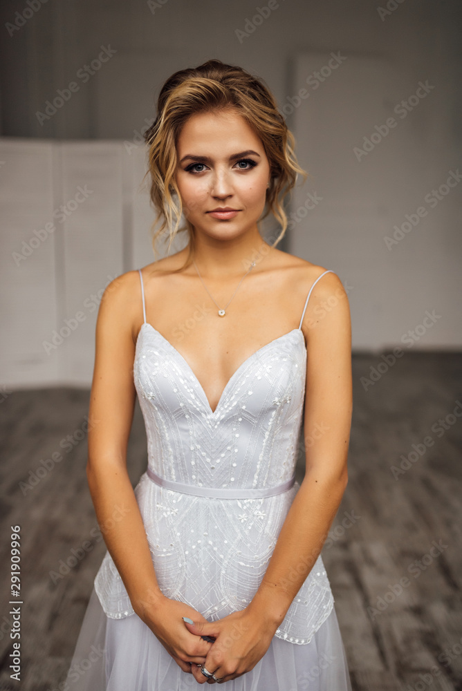 Fototapeta premium bride in beautiful dress in white Studio