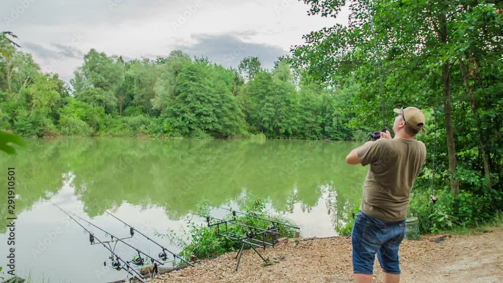 A fisherman is spending an afternoon fishing by the lake. It's a nice and peaceful day. A fisherman is spending an afternoon fishing by the lake. It's a nice and peaceful day.