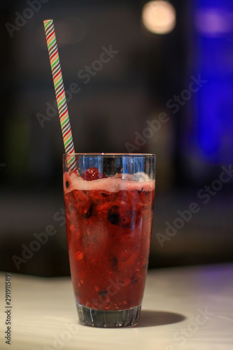 Fruit cocktail served in a tall glass at a bar. 