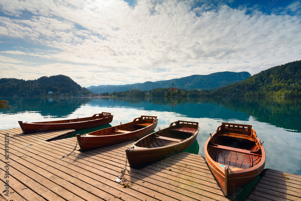 Beautiful landscape with boats moored on lake Bled (Blejsko jezero) in the Julian Alps of Slovenia