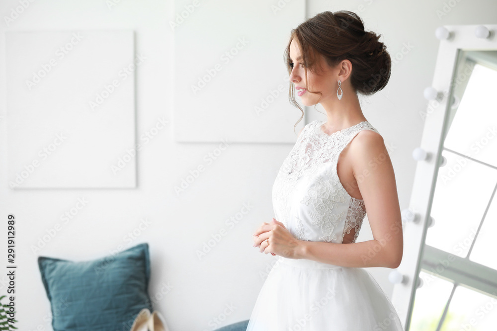 Beautiful young bride before wedding ceremony at home