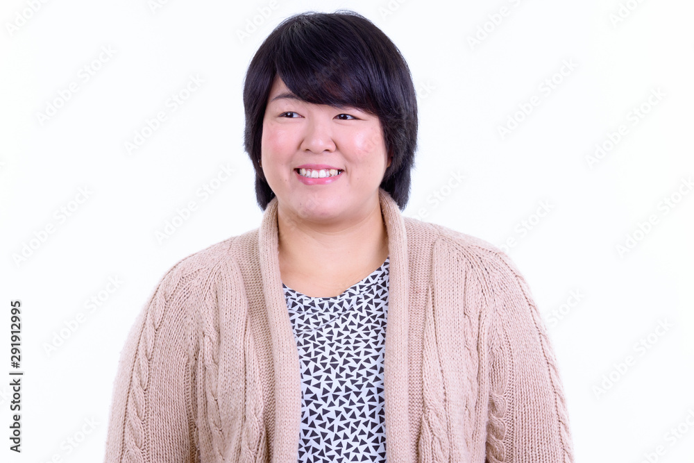 Face of happy overweight Asian woman thinking ready for winter