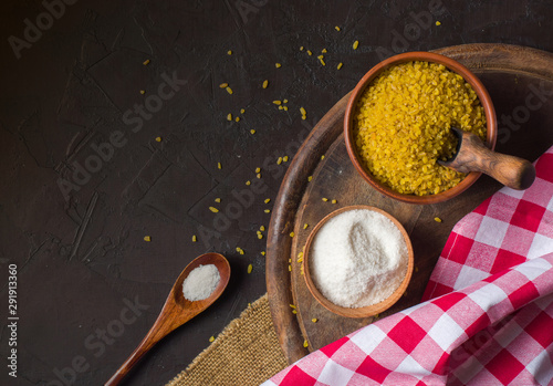 Bulgur on a dark background. wholesome organic food for breakfast or diet. Natural fabrics and earthenware.