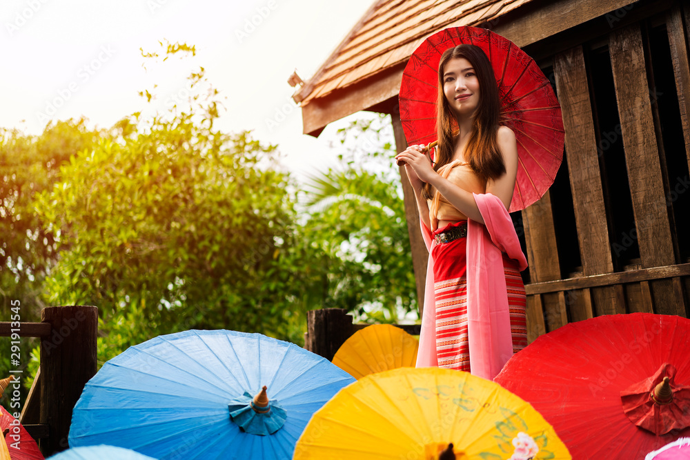 Φωτογραφία Portrait of happy young Asian woman holding red umbrella with copy space for Ad