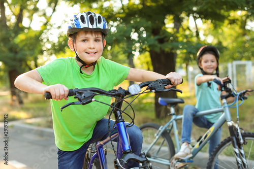 Cute children riding bicycles outdoors