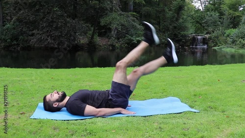 Man doing flutter kicks in park