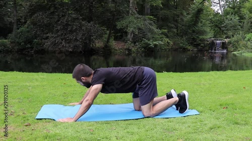 Man doing high plank in park