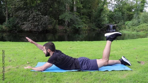Man training lower back aquaman in park