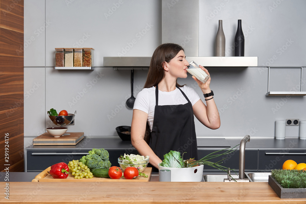 woman in the kitchen drinking milk
