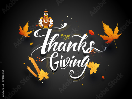 Calligraphy text of Happy Thanksgiving decorated with autumn leaves, wheat ear and turkey wearing pilgrim hat on black background.