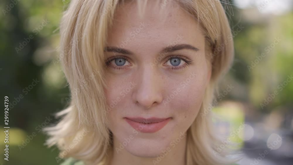 Attractive caucasian woman with medium length haircut looking at camera. Portrait of a beautiful blonde grey-eyed girl. Attractive caucasian woman with medium length haircut looking at camera. Portrait of a beautiful blonde grey-eyed girl.