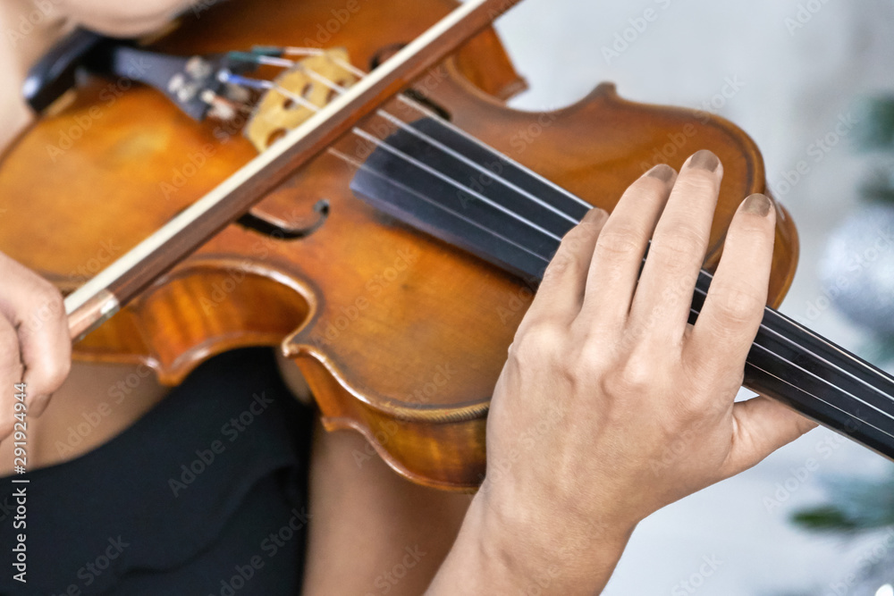 Female violinist with manicure on nails plays violin close up Female violinist with manicure on nails plays violin close up