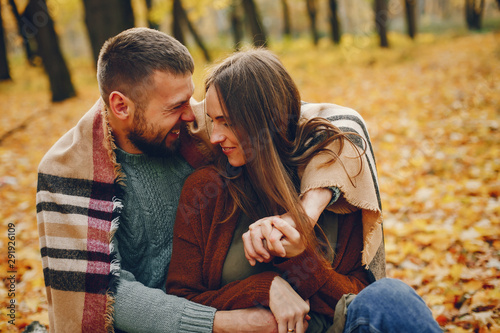 Couple in a park. Woman in a brown sweater. Man with a beard © prostooleh