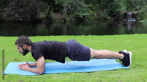 Man doing plank in park
