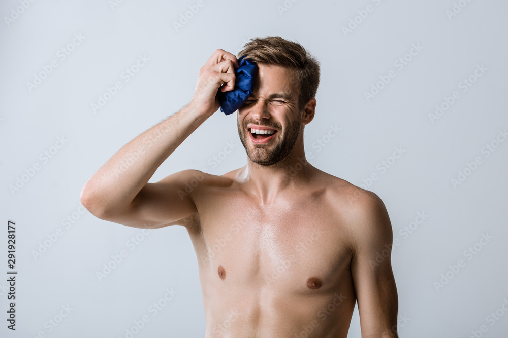 shirtless sportsman using ice for forehead isolated on grey shirtless sportsman using ice for forehead isolated on grey