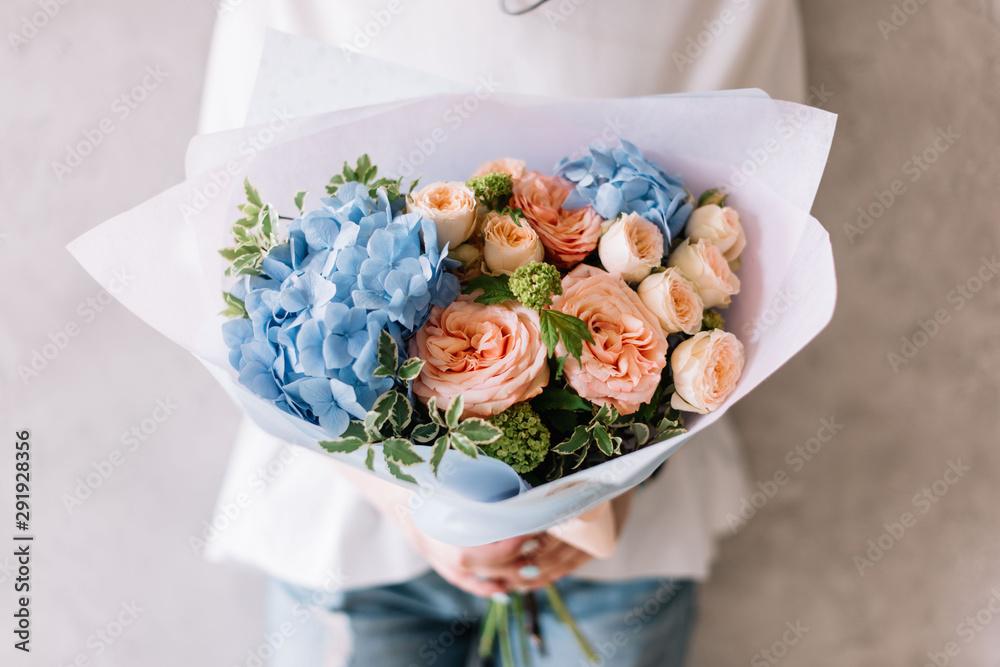 custom made wallpaper toronto digitalVery nice young woman holding a beautiful blossoming flower bouquet of fresh hydrangea, roses, carnations in pink and light blue colours on the grey wall background