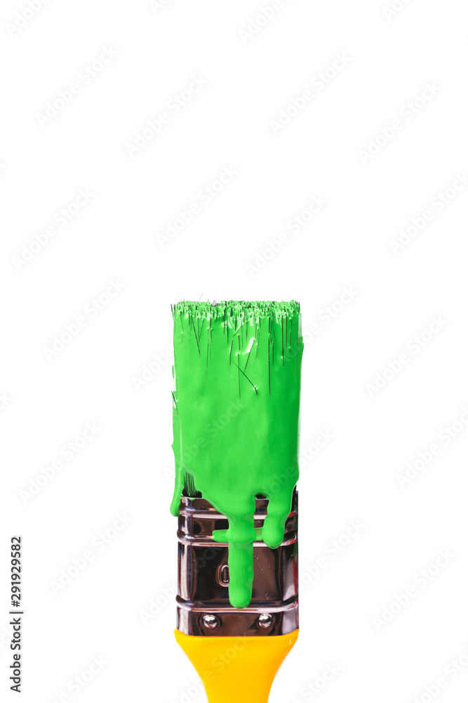 Yellow brush with green color on a white isolated background.