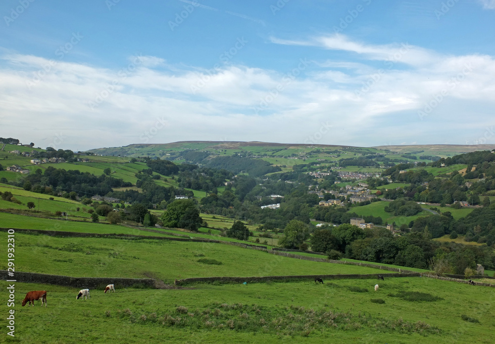 a view of the village of cragg vale in the calder valley surrounded by trees and fields