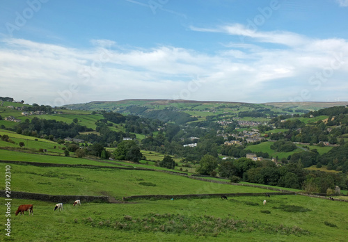 a view of the village of cragg vale in the calder valley surrounded by trees and fields